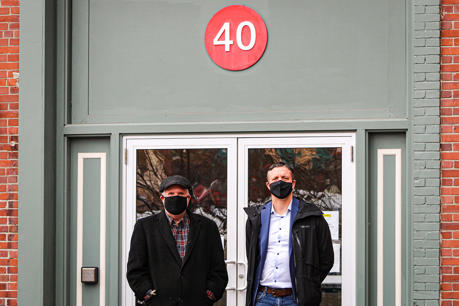 Lee Umphrey (left) and Philip Henry, pictured on Dec. 22, the day Henry purchased 40 Harlow St. from Eastern Maine Development Corporation. Credit: Courtesy of EMDC